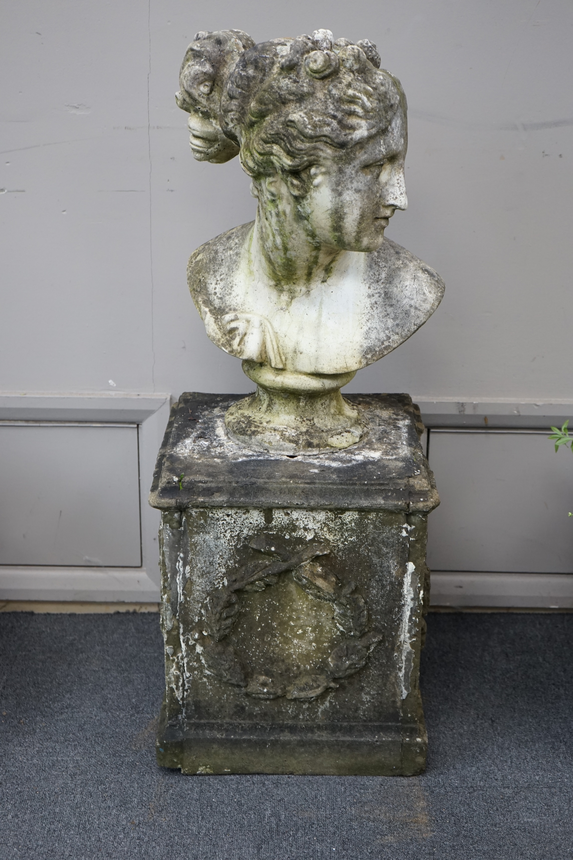 A reconstituted stone bust of Venus, on square pedestal